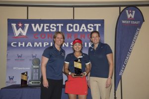 WCC commissioner Lynn Holzman (left), Gonzaga Bulldogs golfer Ciera Min (center), and BYU Cougars associate athletic director Elizabeth Dargar (right) pose for a photo after Min received the individual champion trophy during the WCC Golf Championships at Blackhawk Country Club. Photo courtesy: Kyle Terada/WCC