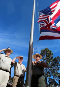 HVNP-Vets-Salute Hawaii Volcanoes National Park volunteers George Jensen (left) and Paul Field salute as Park Ranger Keoni Kaholoa‘a raises the flags outside Kīlauea Visitor Center.
