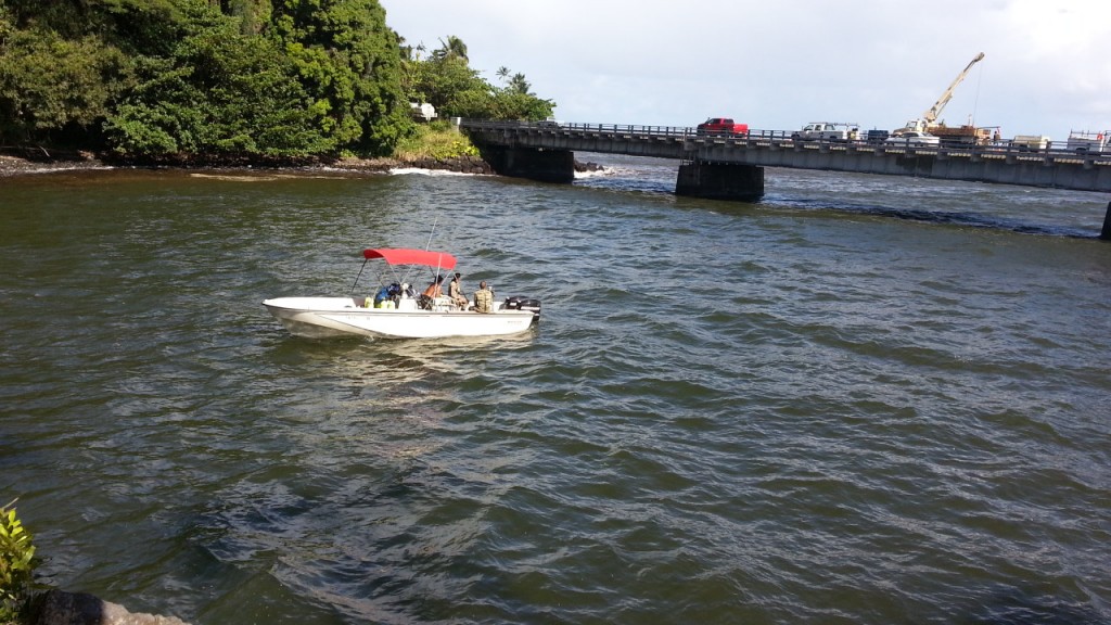 Hawaii Fire Department personnel aboard the Waiakea station's Rescue Boat 2 searching Monday morning for the missing fisherman near the mouth of the Wailuku River. Photo by Dave Smith.