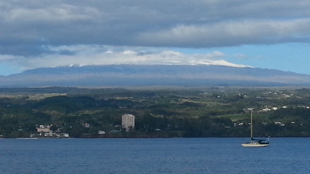 Clouds were beginning to accumulate on Mauna Kea this morning in this view from Hilo's Liliuokalani Gardens. Photo by Dave Smith.