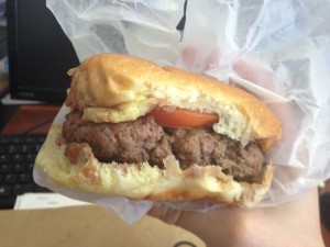 "Working" lunch: a Big Island Now writer attempts to consume a girthy offering from Hilo Burger Joint. Photo by Nate Gaddis.
