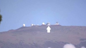 A simulation of how the Thirty Meter Telescope (arrow) would look near the summit of Mauna Kea through a telephoto lens from Waimea. Source: final environmental impact statement, Thirty Meter Telescope Project.