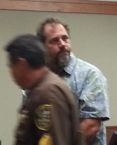 Paul Gibson glances at the gallery following  his hearing today in District Court. Photo by Dave Smith.
