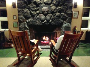 A couple relaxes in front of the iconic Volcano House fireplace. Photo by Nate Gaddis.