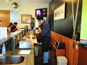 A view of the Takenoko Sushi dining room, chef Igarashi at work. Photo by M's Photography.