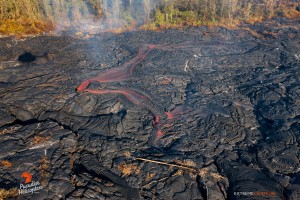 This photo taken Jan. 10 shows a large breakout about 300 yards upslope of the distal tip, poured lava onto the flow field.  Photo: Extreme Exposure Media/Paradise Helicopters.