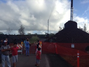 Members of the public venture from the Pahoa Transfer station structure and take a look at the impacted road. Photo credit: Jamilia Epping.