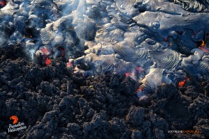 This photo taken on Feb. 4 shows a large breakout of pahoehoe near the perched channel, begins to cover an old ‘a‘a flow. Photo credit: Extreme Exposure/Paradise Helicopters.
