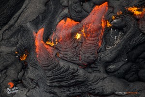 A burning tree trunk gets consumed by pahoehoe in this photo taken on Feb. 9. Photo credit: Extreme Exposure Media/Paradise Helicopters.