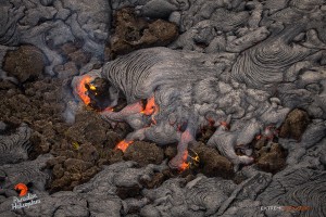 In this photo, taken on Feb. 13, an ‘a‘a flow field is covered by pahoehoe in the vicinity of the perched channel about two miles downslope of Pu‘u ‘O‘o. Photo credit: Extreme Exposure Media/Paradise Helicopters.