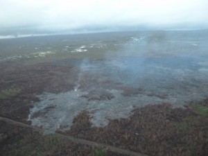 This photo, taken Feb. 24, shows a breakout along the north margin of the June 27 lava flow, looking down slope towards Highway 130. Civil Defense photo.