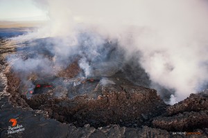 This photo, taken Feb. 26, shows a couple collapse pits that had been sloshing lava within Pu‘u ‘O‘o crater. Photo credit: Extreme Exposure Media/Paradise Helicopters.