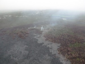 This photo, taken March 9, shows a view from the south flow margin, looking down slope towards Apaa Street. Hawai'i County Civil Defense photo.