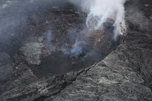 There are several incandescent and outgassing hornitos on the floor of Puʻu ʻŌʻō's crater, including the one shown in this photo, taken on March 24, which is at the northeast edge of the crater. Recent flows from the hornito appear black. USGS HVO photo.