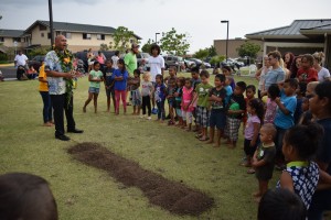 Children and residents of The Homes at Ulu Wini gather around Kahu Brian Broshard, who led the playground blessing and groundbreaking ceremony. HOPE Services Hawai'i photo.
