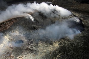 This photo, taken April 3, shows a new collapse pit that formed in the western portion of Puʻu ʻŌʻō Crater since March 27. This circular pit can be seen in the lower left portion of the photograph, and measures about 27 m (roughly 90 ft) in diameter. Numerous hot cracks were also observed in this general area during previous visits on foot. USGS/HVO photo.