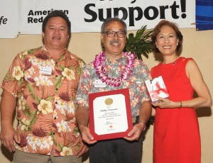 Photo of West Hawaii Volunteer of the Year Phillip Fernandez at Saturday’s Red Cross Heroes recognition event with award presenters Mike Kaleikini of Puna Geothermal and Coralie Chun Matayoshi, CEO, Hawai'i Red Cross. Hawai'i Red Cross photo.