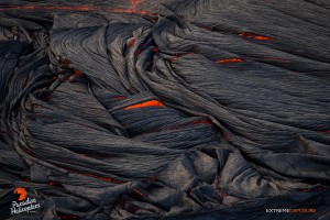 June 11: Folds of pahoehoe curl over and crack, revealing the orange glow of the molten lava within. Photo: Extreme Exposure Media/Paradise Helicopters.