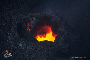2015 06 25 - Puna, Hawaii:  A skylight offers a peek into the fiery depths beneath Pu‘u ‘O‘o crater's floor.   Photo: Extreme Exposure Media/Paradise Helicopters