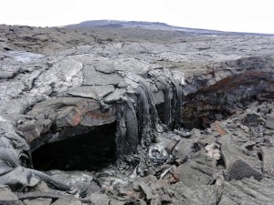 June 4: Recent lava on the June 27 flow cascaded over the overhanging rim of this collapse pit on an earlier portion of the flow field. USGS/HVO photo.