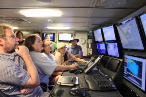 The science team watches the CTD live fromt he control room on board Falkor. Photo credit: SOI/Carlie Wiener.