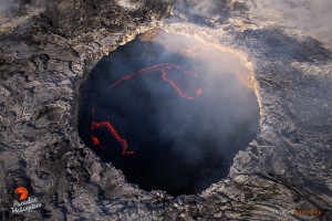 Aug. 6: With the winds blowing from the south, we had the rare opportunity to fly directly over the collapse pit within Pu‘u ‘O‘o crater, and watch the lava pond consume hardened plates of its cooled surface in the subduction zone along its edge.  Photo: Extreme Exposure Media/Paradise Helicopters.