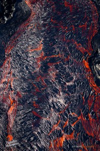 Aug. 27:  A shot taken from directly over raging river of lava.  Chunks of the lava's cooling surface float downslope.  Photo: Extreme Exposure Media/Paradise Helicopters.