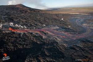 Aug. 27:  A significant breakout occurred around 1 am this morning on the northern flank of Pu‘u ‘O‘o, and it has advanced to the approximately 1/3 of a mile to the northwest as it spreads out on the flow field. It seems to be flowing over the general path of the tube that transports lava to the distal tip, so it's possible that an obstruction has occurred within it, forcing lava to the surface.   Photo: Extreme Exposure Media/Paradise Helicopters.