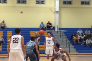 Kealakehe's Treswit Francis (21) goes for the opening tip against Baldwin's Sam Balantac (30). Photo by Josh Pacheco.