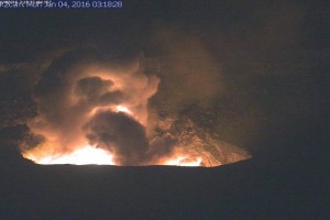In this image, captured by a USGS Hawaiian Volcano Observatory webcam, the dusty gas plume can be seen rising from the vent after rocks impacted the lava lake. Incandescence from molten lava exposed by the disrupted lava lake surface lit up the vent wall and the night sky above Halemaʻumaʻu Crater. HVO image.