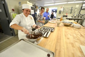 Culinary Arts student makes chocolate truffles for visitors at the Open House and Grand Opening Celebration. The new campus features two new teaching kitchens with brand new equipment. Hawai’i Community College – Pālamanui photo.