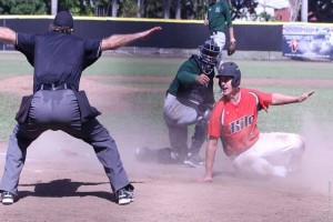 UH-Hilo first baseman Phillip Steering slides in safely at home ahead of a tag by Hawai'i catcher Chayce Ka'aua. UH-Hilo photo.