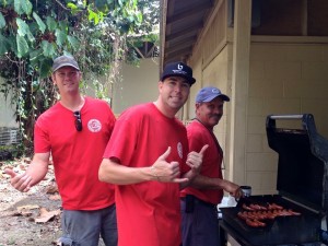 Past Hawai'i Island Portuguese Chamber of Commerce Presidents Charles Ensey, Joe Marsh, and Billy Andrade grill Portuguese sausage hot dogs at Carvalho Park during last year's event. Courtesy photo: Larkin Correia.