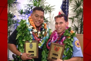 Police Officer Ryan Pagan and Fire Captain Garrett Kim display plaques from the Aloha Exchange Club of East Hawaiʻi. HPD courtesy photo.