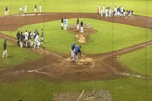 Players from Waiakea and Hilo work together to dry the field at Wong Stadium during a 46-minute rain delay. Photo by Josh Pacheco.