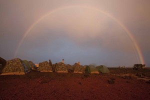 A rainbow arches over falling over the Pohakuloa Training Area during a during Rim of the Pacific (RIMPAC) 2010 training exercise. U.S. Marine Corps photo by Lance Cpl. Reece E. Lodder.