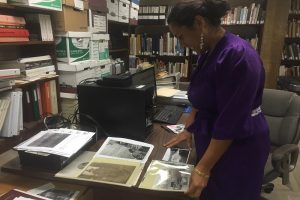 In Kona Historical Society's archives, Mina Elison, curator and future Kona Museum Gallery director, works on the two "Kona Ranching and Kona Cowboys" exhibits that will be presented this summer. Photo By Carolyn Lucas-Zenk | Kona Historical Society.