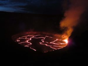 A wide view looking northeast, of the lake in Halemaʻumaʻu Crater as seen late Monday. Jaggar Museum and HVO are beyond the left edge of the photograph. Spattering was active in the southeast portion of the lake. The lava lake dropped more than 15 m (49 feet) between the time the photo was taken and mid-day Thursday, June 30, 2016. USGS photo.