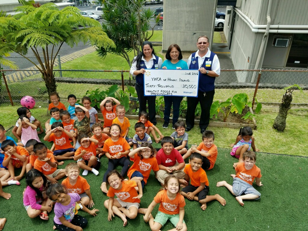 (Standing in the rear holding the check, left to right) Hilo Walmart Co-manager Sharyn Richardson, YWCA of Hawaii Island Preschool Director Lissa Van Kralingen, and Hilo Walmart store Manager Jerod Strong. Courtesy photo.