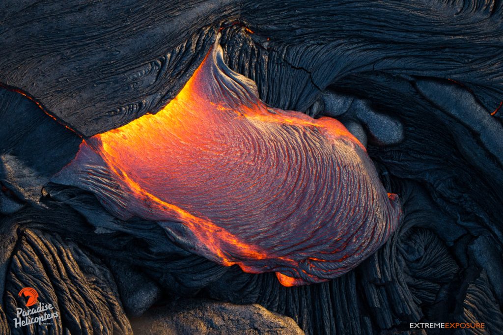 A toe of pahoehoe oozes out from beneath the ruptured crust of the leading edge. Hawaiian Helicopters, Aug. 25, 2016.