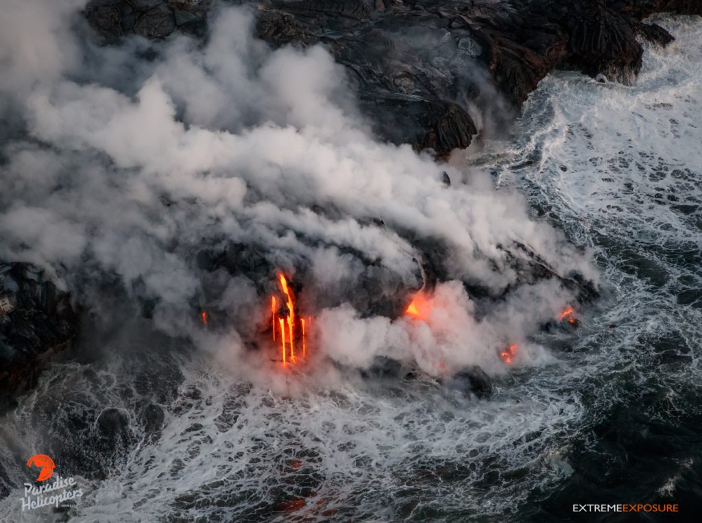 8 Lava continues to pour into the sea, growing the new delta of land at the base of the sea cliff at Kamokuna. Hawaiian Helicopters, Aug. 25, 2016.