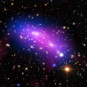 Massive galaxy cluster MACS J0416 seen in X-rays (blue), visible light (red, green, and blue), and radio light (pink). CREDIT: NASA/CXC/SAO/G.OGREAN/STSCI/NRAO/AUI/NSF.