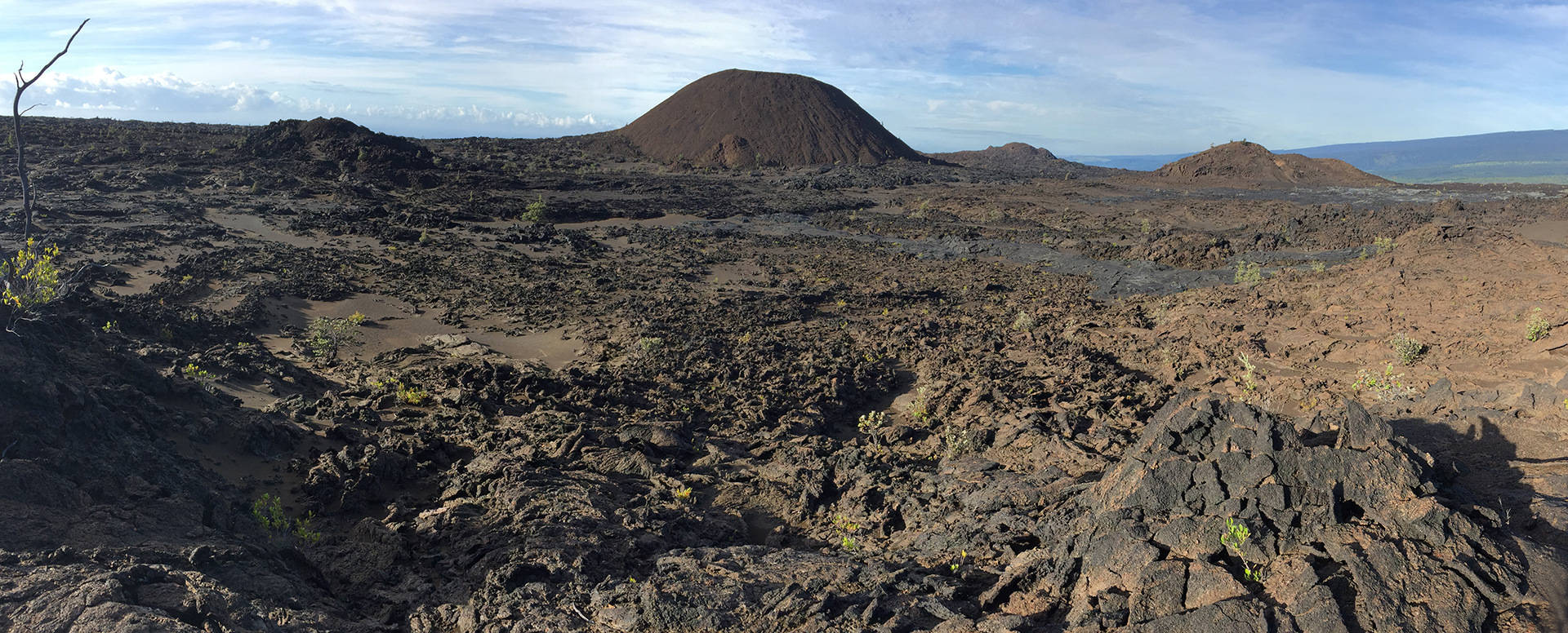 Shown here are three of the main volcanic cones (center and right) that make up the Kamakaiʻa Hills on Kīlauea Volcano’s Southwest Rift Zone. Findings from a study of the Kamakaiʻa Hills that is currently underway by the USGS Hawaiian Volcano Observatory will likely revise the known geologic history of this remote area on Kīlauea and provide new insights on past and future eruptions along the volcano's Southwest Rift Zone. USGS photo.