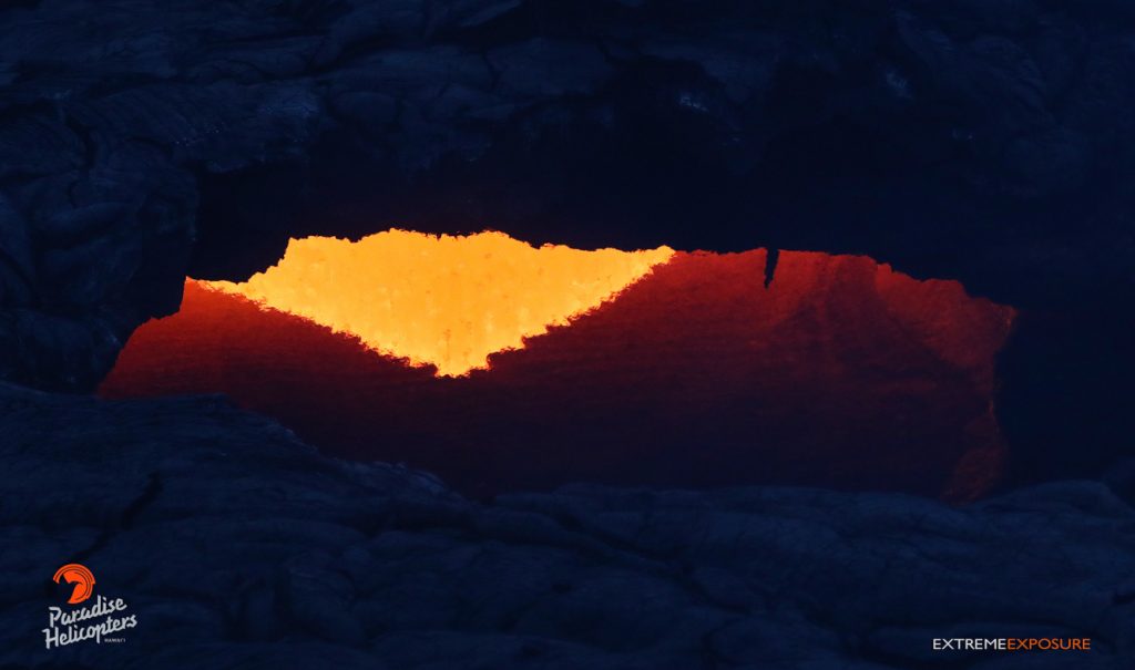 A large skylight about a mile and a half downslope of Pu‘u ‘O‘o allowed a peek at the river of lava feeding flow 61G. Tropical Visions Video photo.