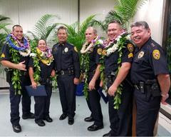  Officer Bryan Tina, Officer Kristi Crivello, Chief Harry Kubojiri, Sergeant Brandon Konanui and Deputy Chief Paul Ferreira pose with Captain Robert Wagner (fourth from left), who was named Hawaiʻi County Manager of the Year.