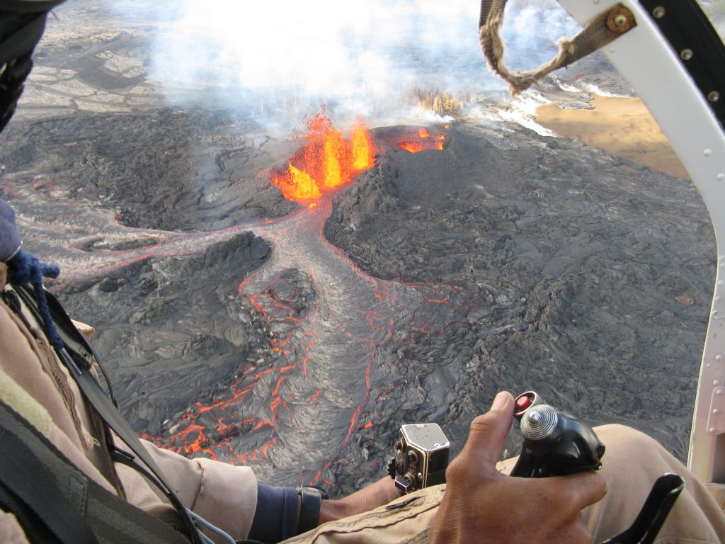  Helicopter transport is the only way HVO scientists and technicians can install and maintain many monitoring instruments on the Island of Hawai`i, conduct field experiments or map new volcanic deposits in inaccessible areas, and make direct observations of eruptions. Pilots that fly the helicopters and mechanics that maintain them to the highest standards are crucial to us in performing our work safely and to report reliably on the status and eruptions of Hawaii`s active volcanoes. Eruption of Kīlauea Volcano on March 8, 2011, visible through the cockpit of a small helicopter piloted by David Okita, Volcano Helicopters. USGS photo.