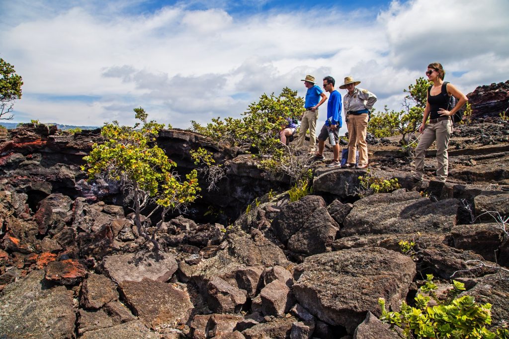 Visitors enjoy a guided hike to Pu‘ū o Lokuana cindercone. NPS photo/Janice Wei