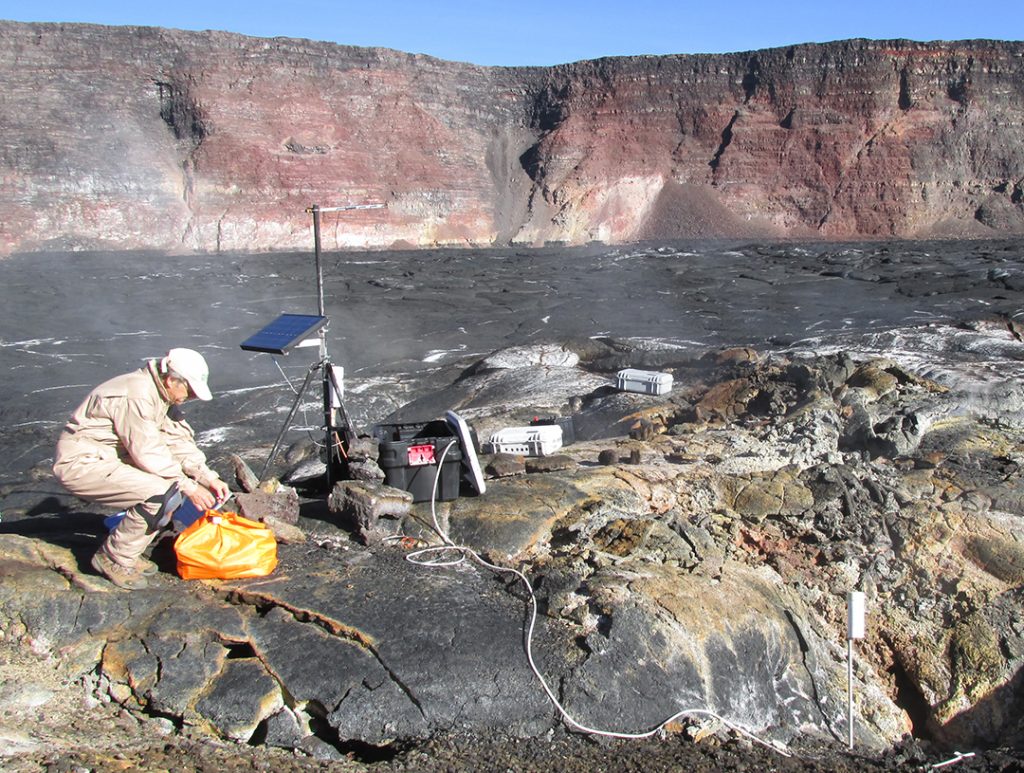 Hawaiian Volcano Observatory scientist monitoring gas emissions on Mauna Loa in 2015. USGS photo.
